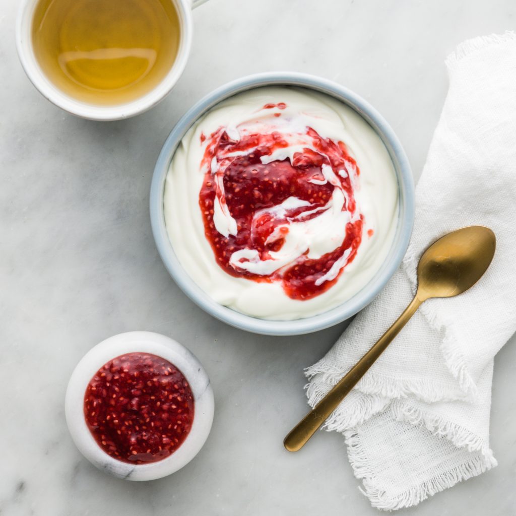 Bowl of greek yoghurt with chia raspberry jam