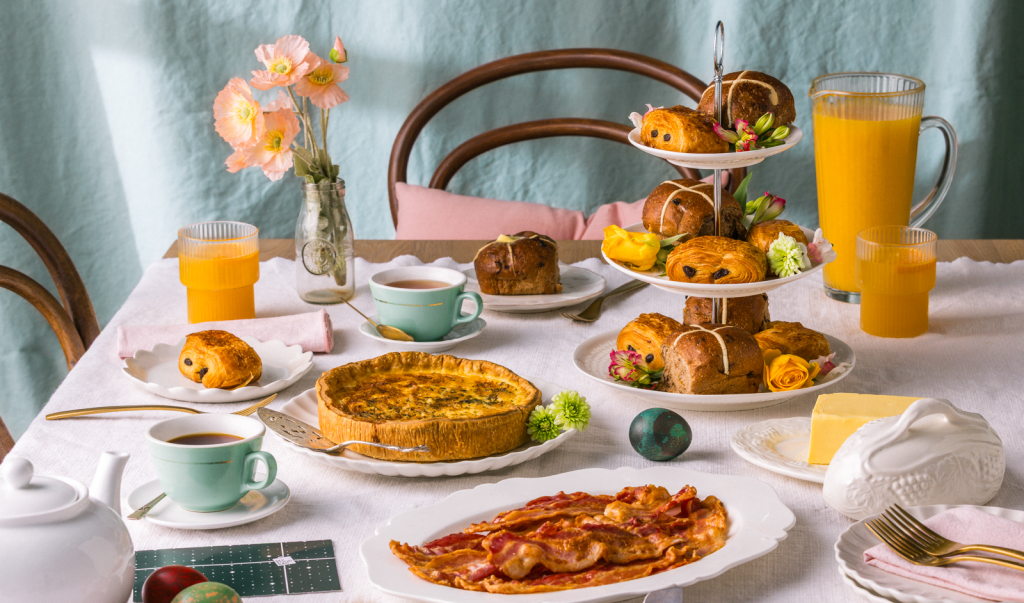 Easter brunch with pastries, bacon and juice.