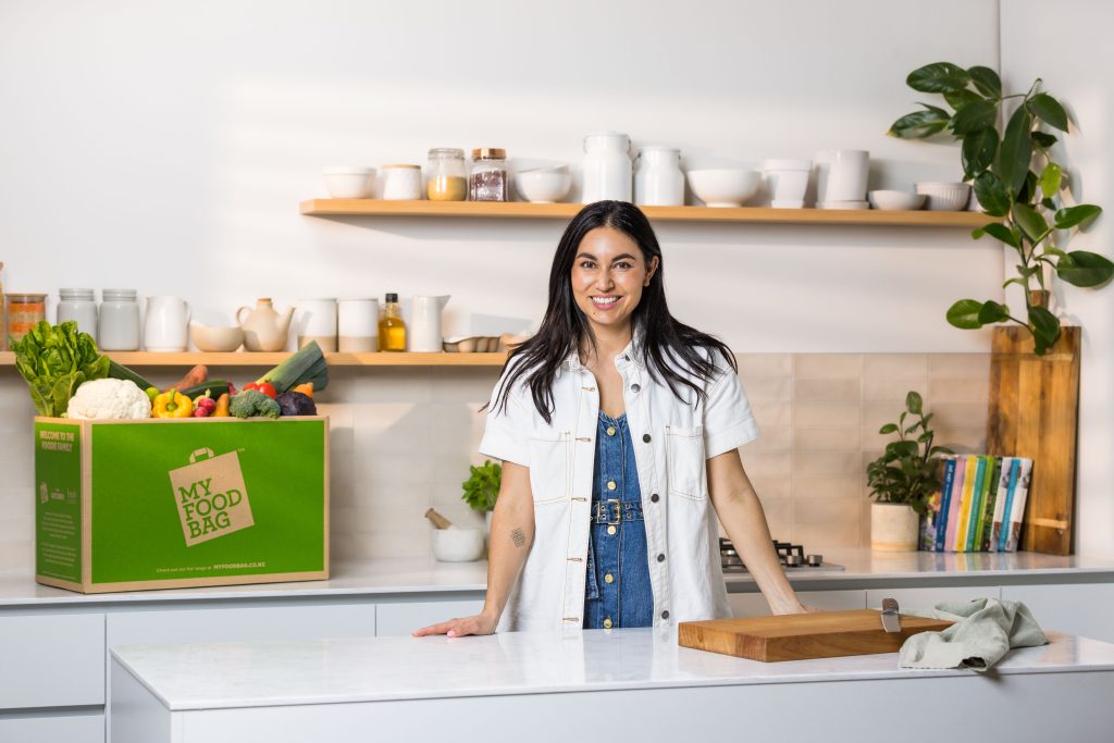What is the Best Meal Kit in New Zealand? The Ultimate Guide 1 Nadia Lim with a My Food Bag meal kit box in a kitchen.