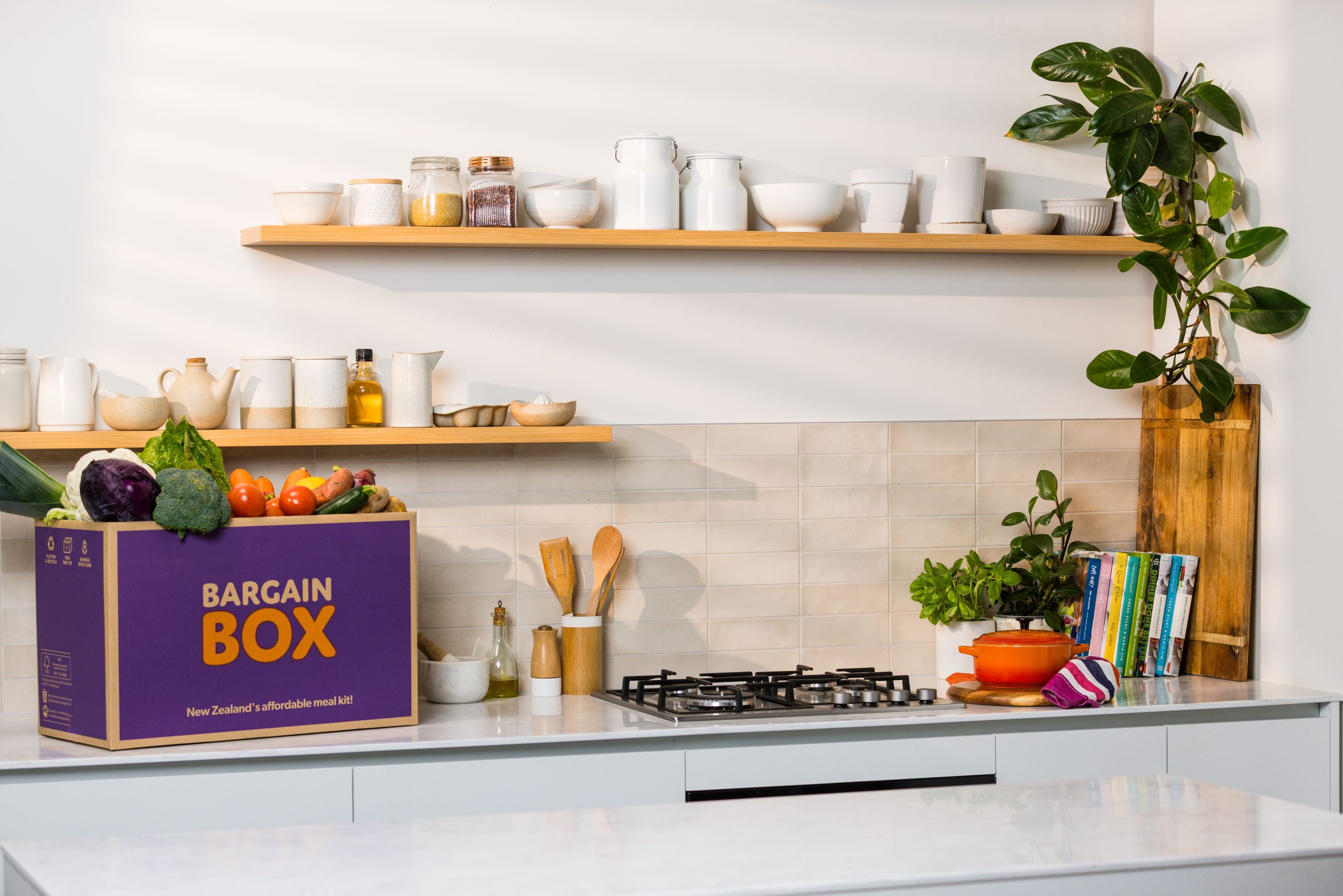 A Bargain Box meal kit filled with groceries on a kitchen bench